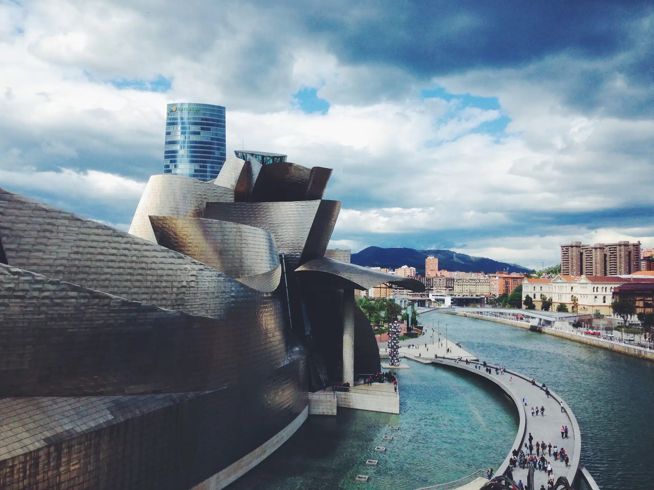 Bilbao riverfront lined with autumn trees
